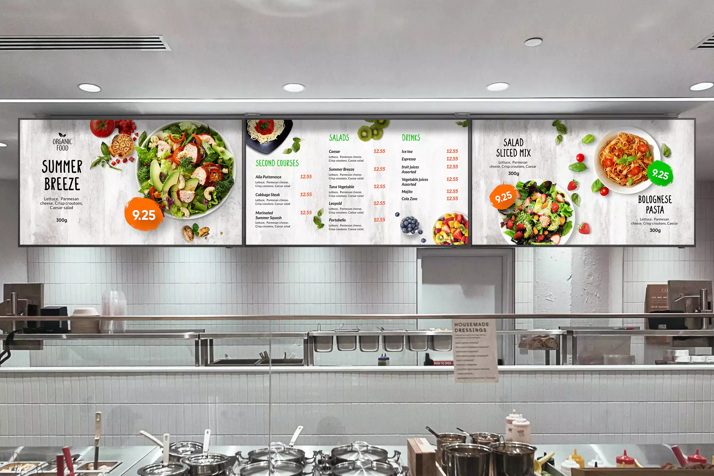 Digital menu boards mounted above a modern fast-casual assembly line